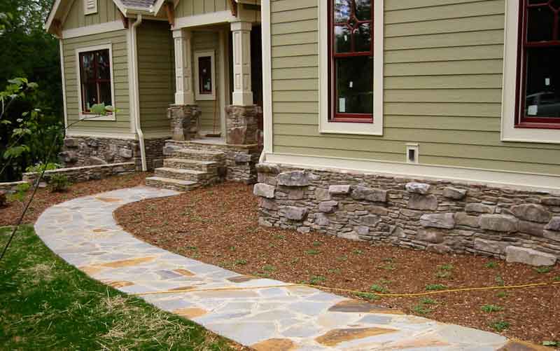 Stone pathway, entrance stairs and foundation wall